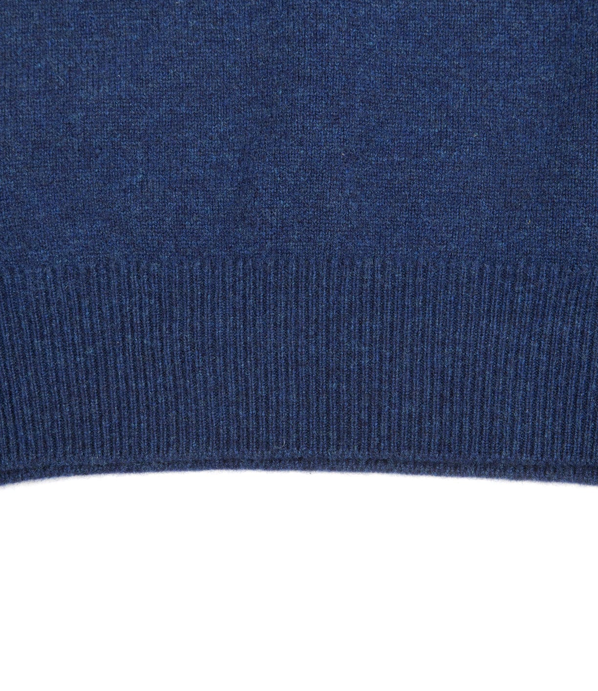 Close-up of the Lightweight Shetland Sweater by Best Made Co., showing dark blue lambswool and ribbed hem detail, crafted by Scottish woolen mills.