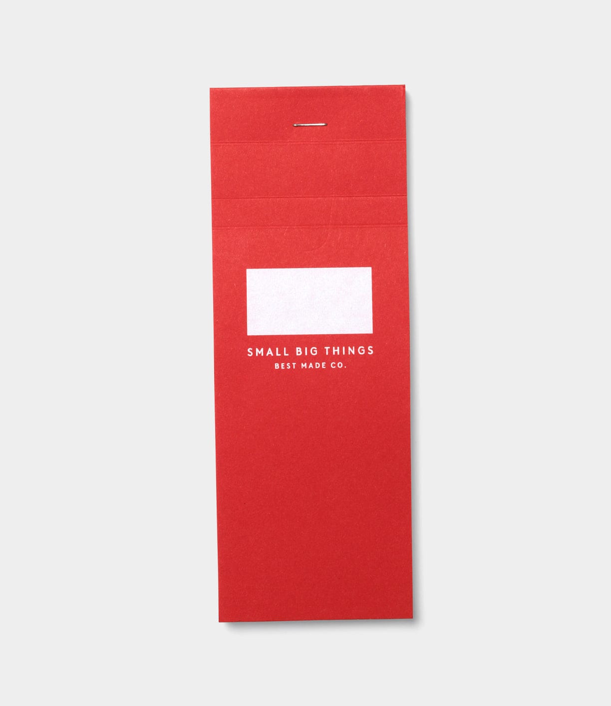The S.B.T. List Pad by Best Made Co is a red portable notebook with a white label area and "SMALL BIG THINGS BEST MADE CO." printed below it on the cover, ideal for lists, shown on a light gray background.