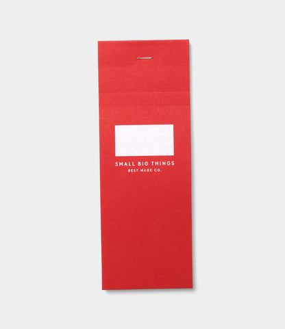 The S.B.T. List Pad by Best Made Co.—red with a silver staple and a white label—is displayed on a light grey background.