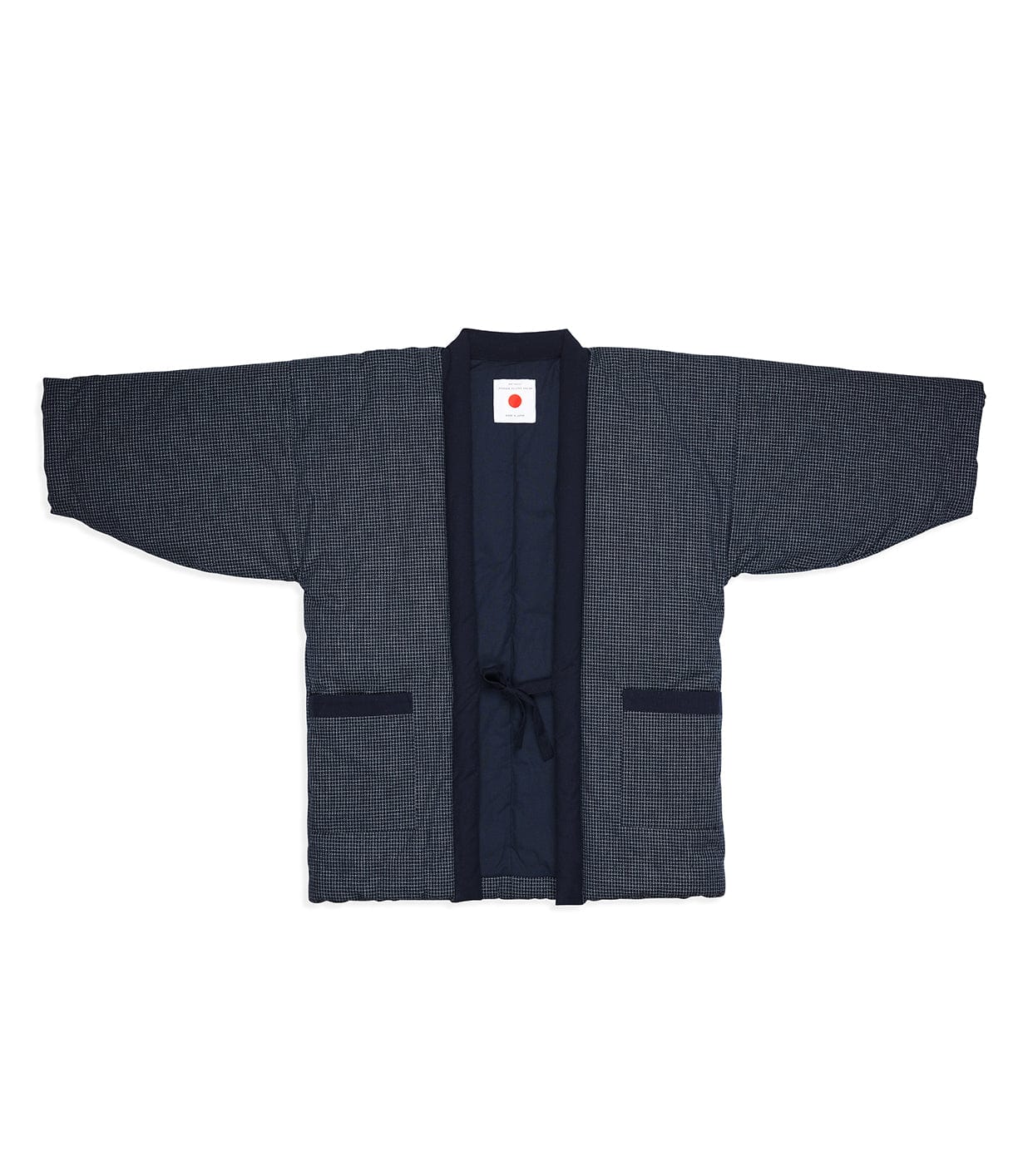 The Best Made Co. Quilted Hanten Jacket is a dark blue Japanese-style jacket with wide sleeves and a front tie, shown flat against a white background.